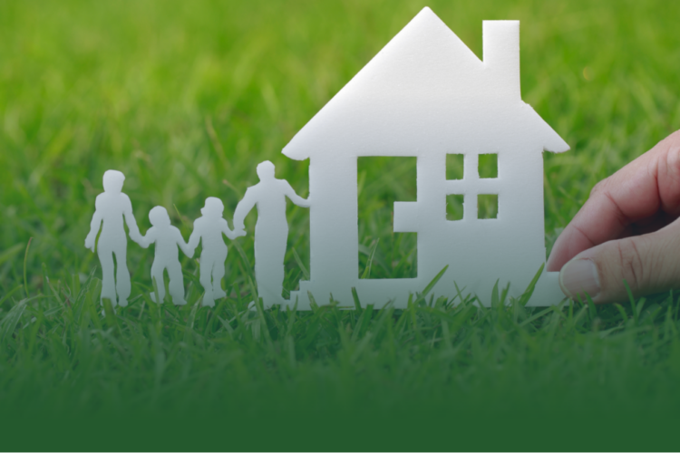 White silhouette of a family and a house against a green grass background